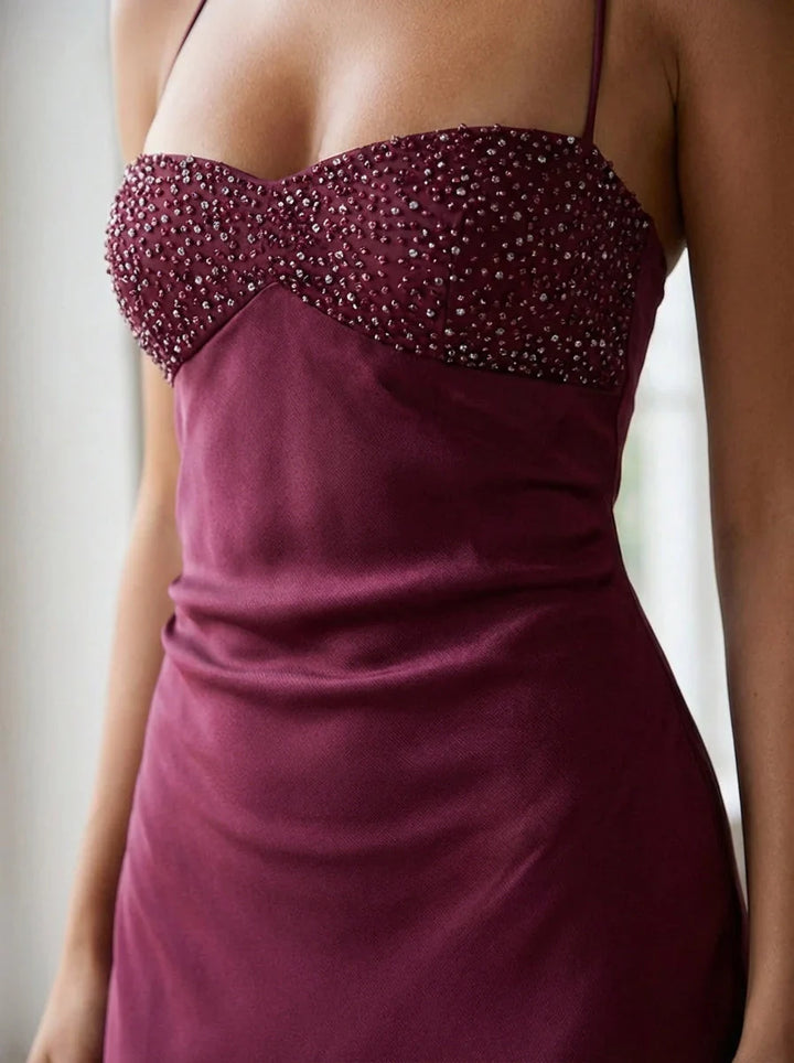 Evening maxi dress with halter neck straps and beaded empire waist bodice