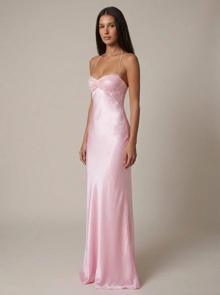 Front view of pink halter maxi dress showing empire waistline and beaded neckline detail