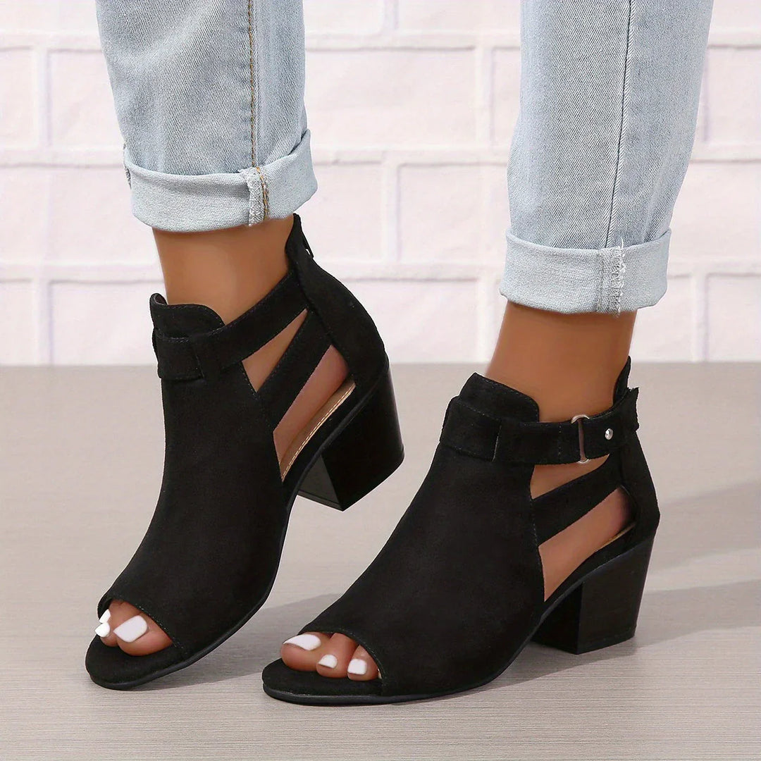 Close-up view of women's block heel sandals showing cut-out ankle detail and stacked heel construction