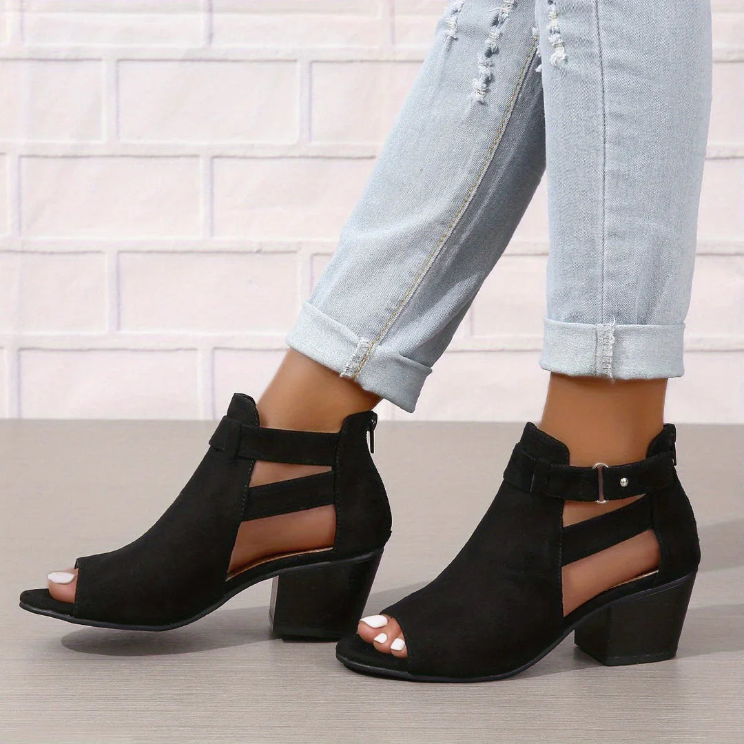 Women's block heel sandals worn with rolled-up jeans showcasing peep toe and ankle strap
