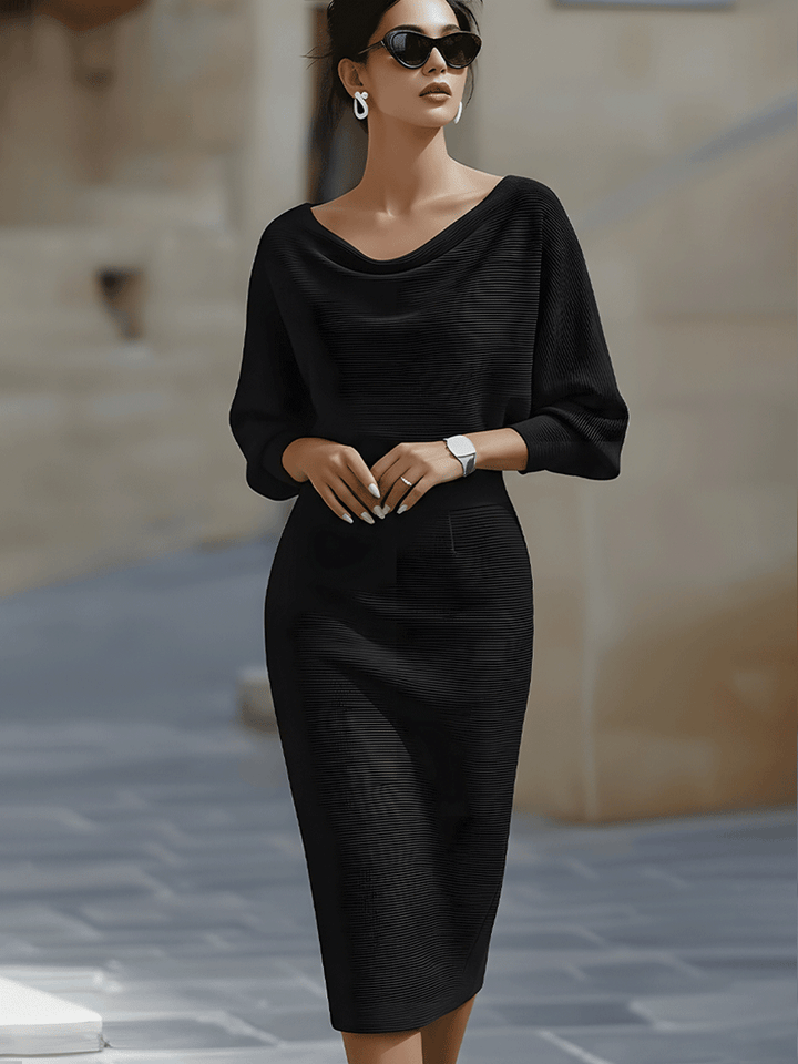 Close-up view of the draped boat neckline and batwing sleeve detail on the midi bodycon dress