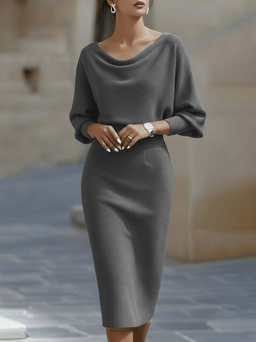 Side profile showing the sculpted bodycon silhouette and midi length of the ribbed knit dress