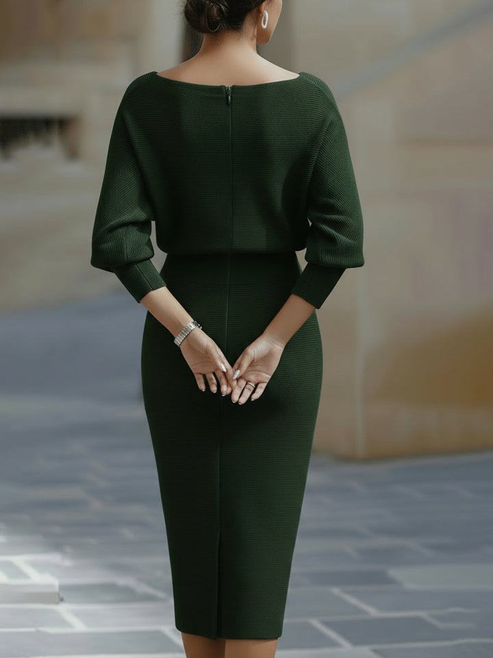 Close-up of the fitted waist and midi-length hem on the batwing sleeve dress