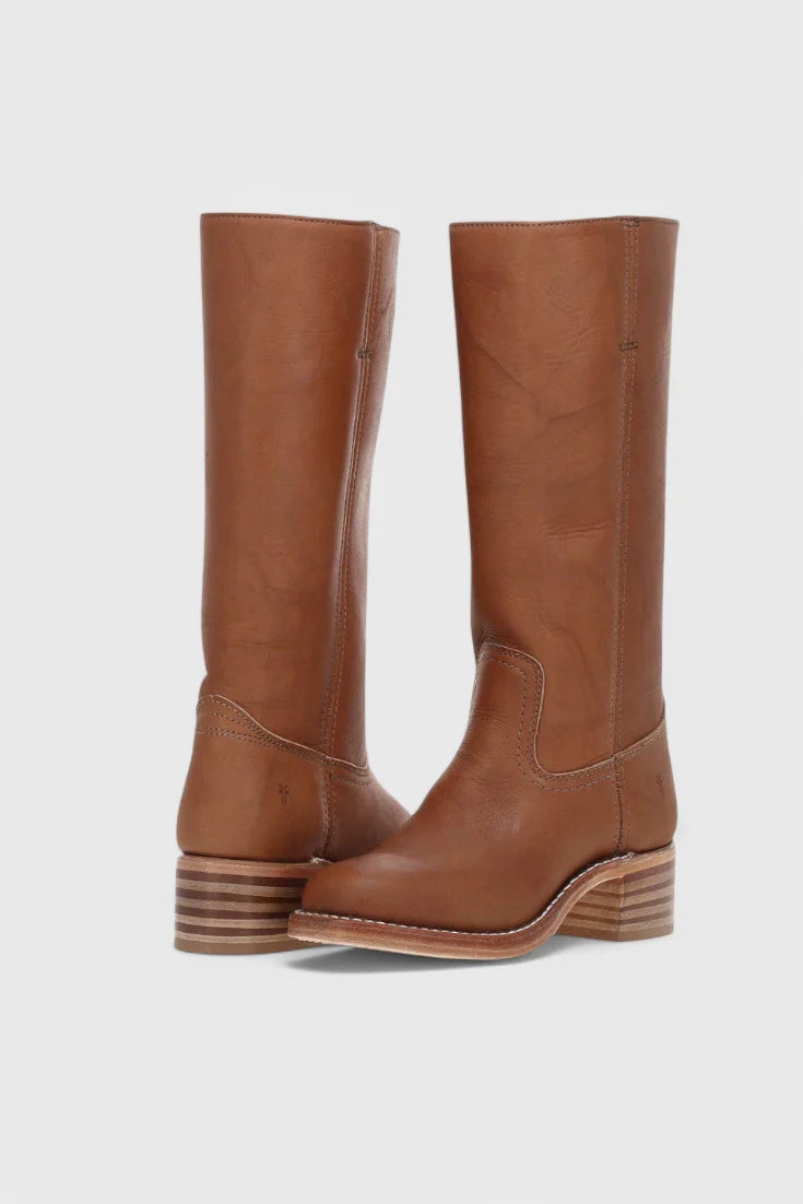 Side profile of knee-high heeled boots with structured shaft and block heel construction