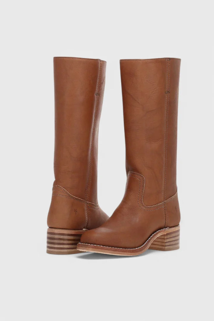Side profile of knee-high heeled boots with structured shaft and block heel construction
