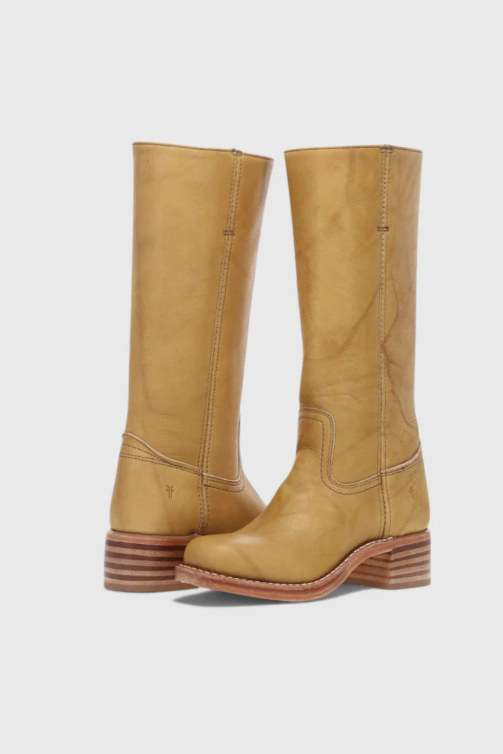 Full-length view of women's knee-high heeled boots in yellow with pull-on design