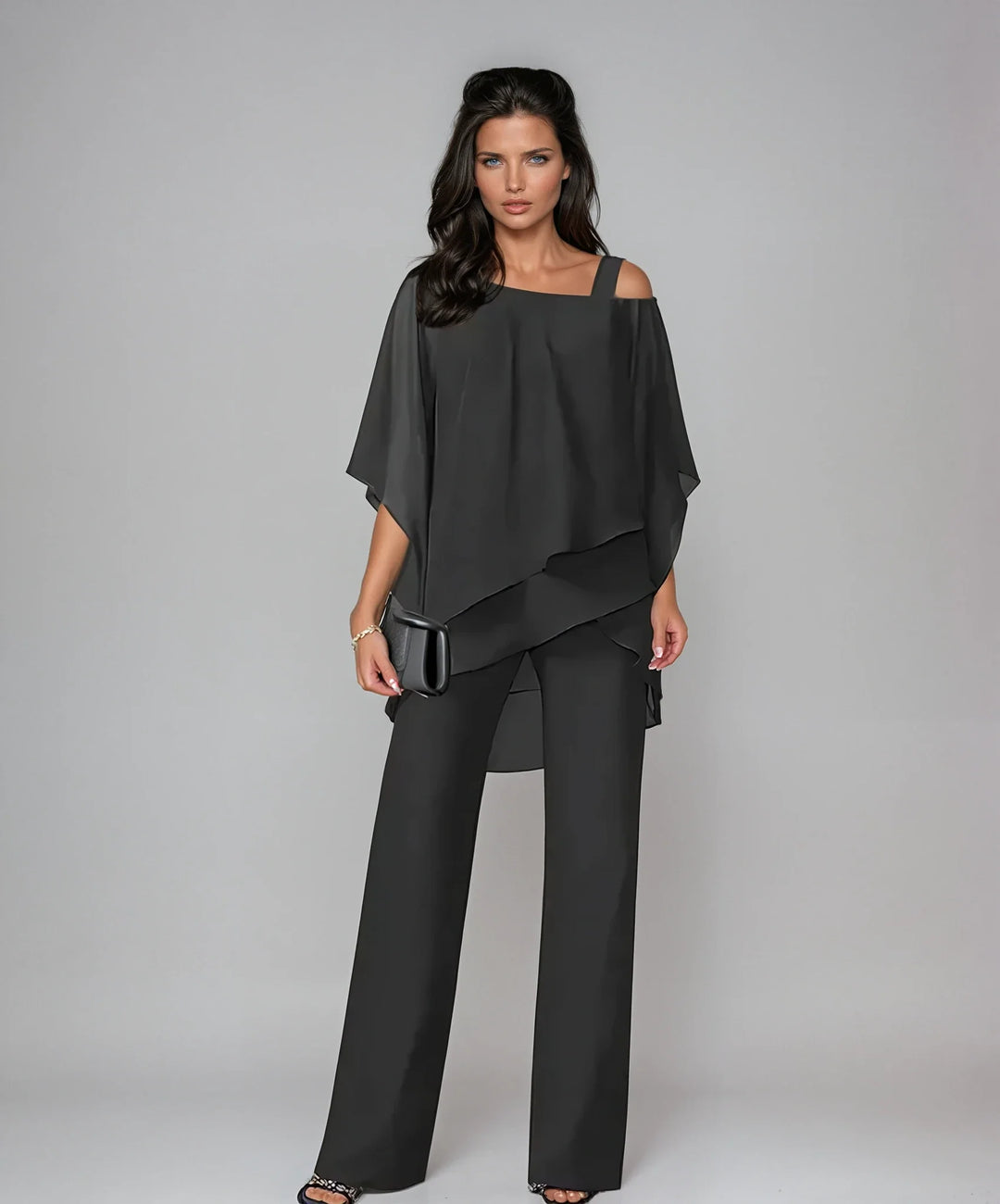 Close-up view of cold shoulder detail and flowing layered panels on two-piece set