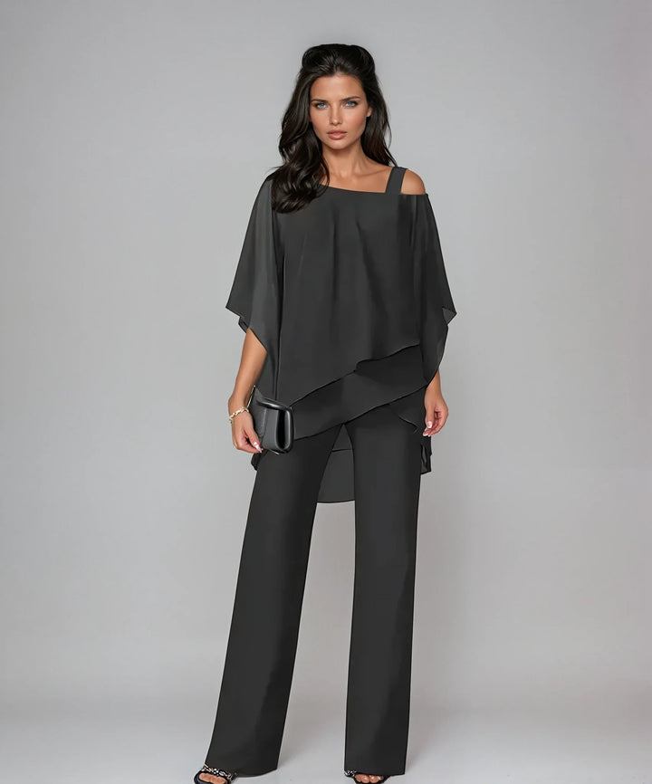 Close-up view of cold shoulder detail and flowing layered panels on two-piece set