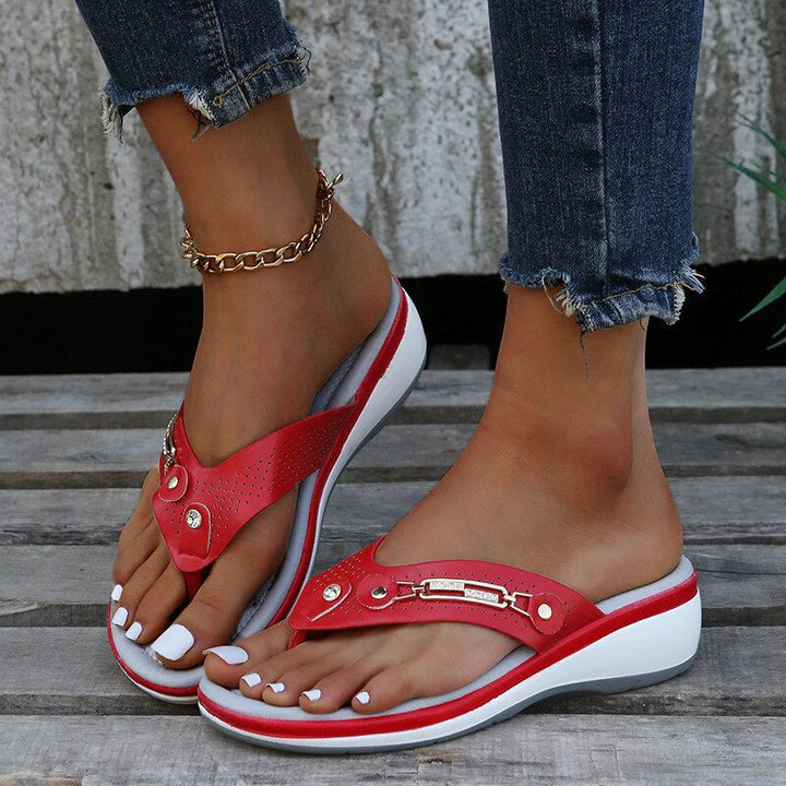 Women's orthopedic flip-flop sandals featuring cushioned insole and decorative hardware accent on upper