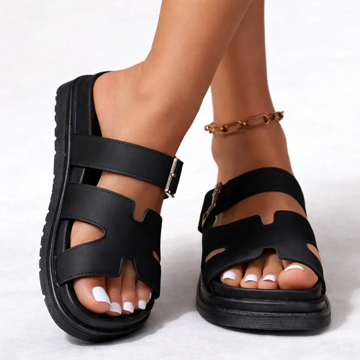 Women's platform sandals in black with contoured footbed and adjustable ankle buckle strap