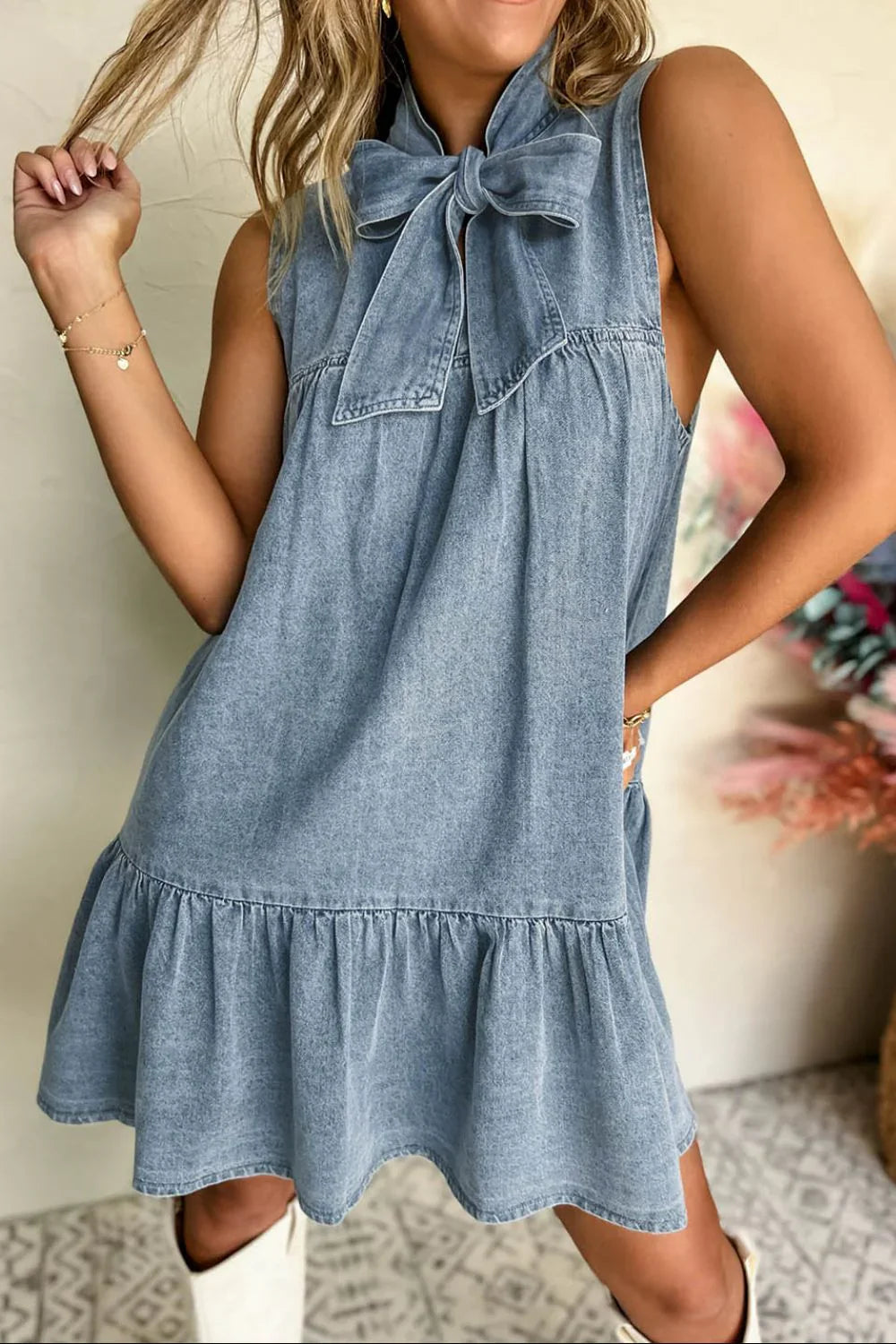 Back view of sleeveless chic summer dress showing bow tie closure at neckline