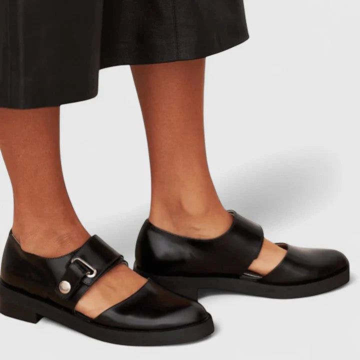 Annabelle wearing Modern Cut-Out Buckle Mary Jane Shoes in black with architectural cut-out design and statement buckle strap