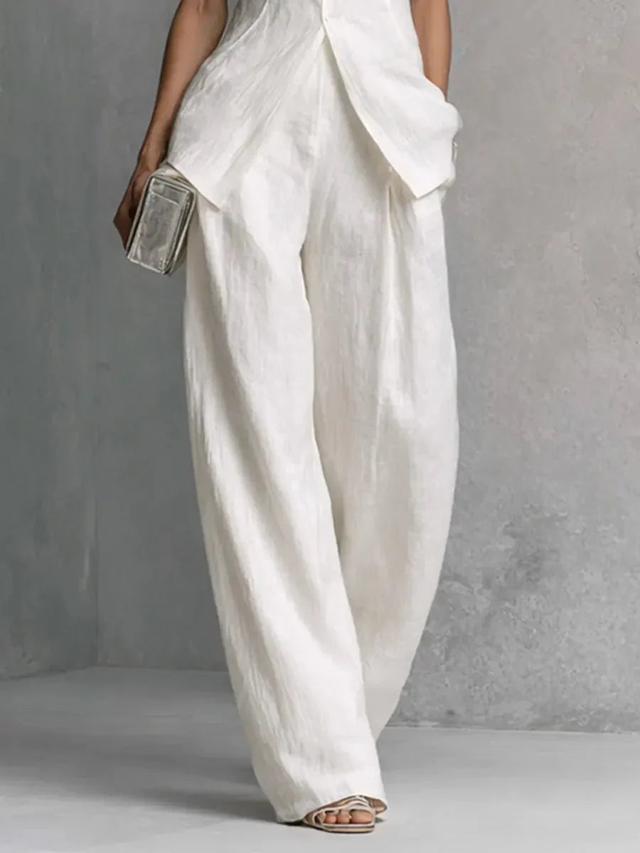 Back view of Women's Cotton-Linen Stand-Collar Wide-Leg Two-Piece Set showing high-low hemline and trouser drape
