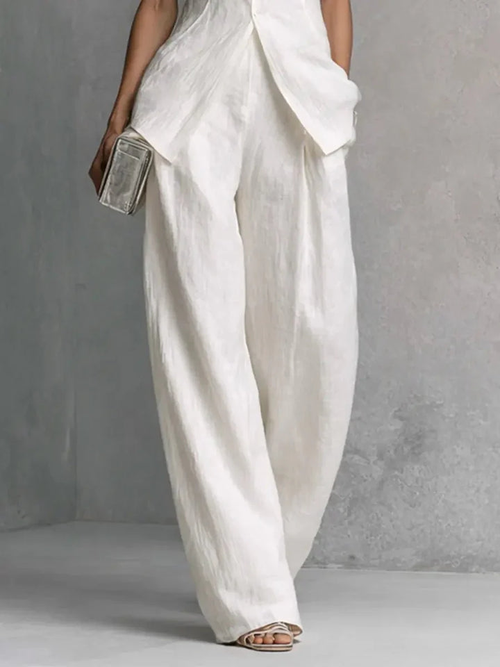 Back view of Women's Cotton-Linen Stand-Collar Wide-Leg Two-Piece Set showing high-low hemline and trouser drape