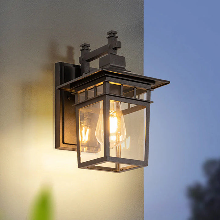 Arthur outdoor waterproof lantern wall light with aluminium frame and clear glass panels mounted on exterior wall
