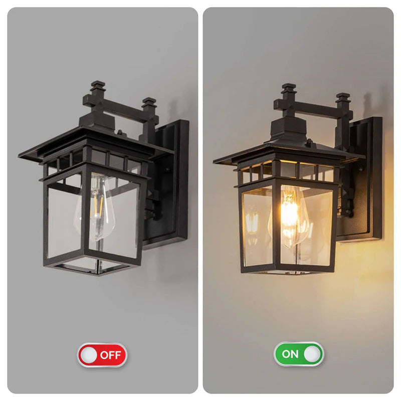 Night-time view of outdoor waterproof lantern wall light with visible filament bulb through clear glass