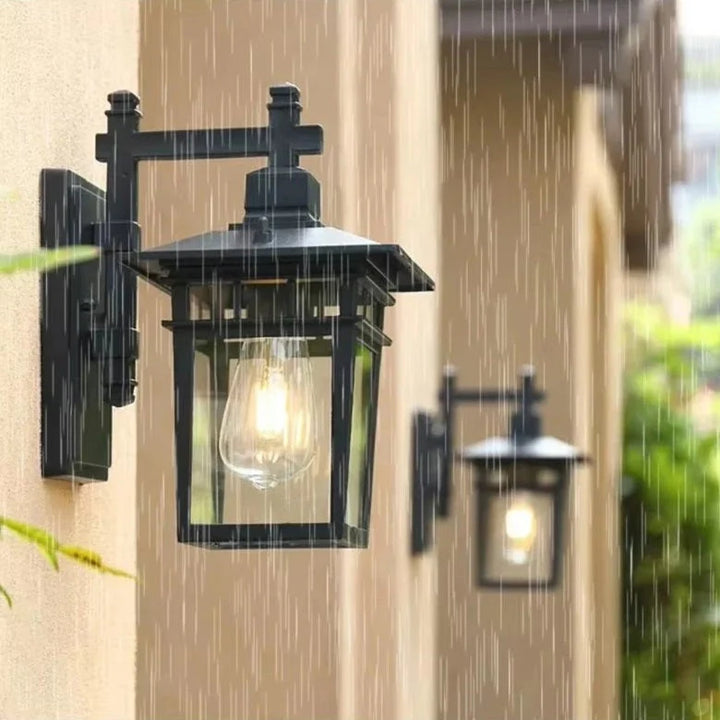Side angle of outdoor waterproof lantern wall light displaying protective roof overhang and wall bracket