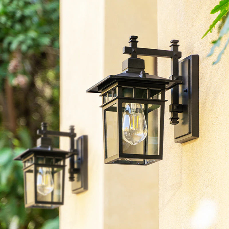 Outdoor waterproof lantern wall light black finish mounted beside entrance doorway with warm illumination
