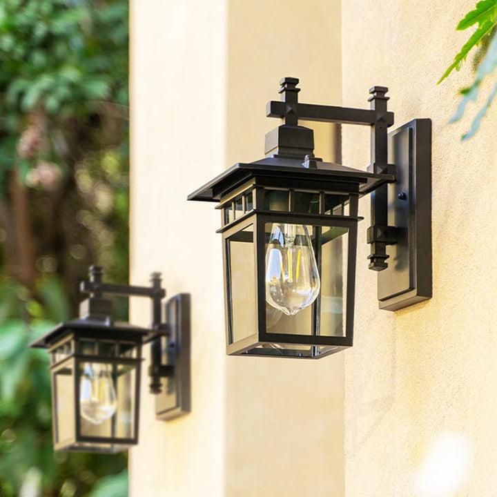 Outdoor waterproof lantern wall light black finish mounted beside entrance doorway with warm illumination