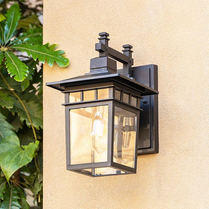 Copper finish outdoor waterproof lantern wall light casting ambient glow on exterior wall surface