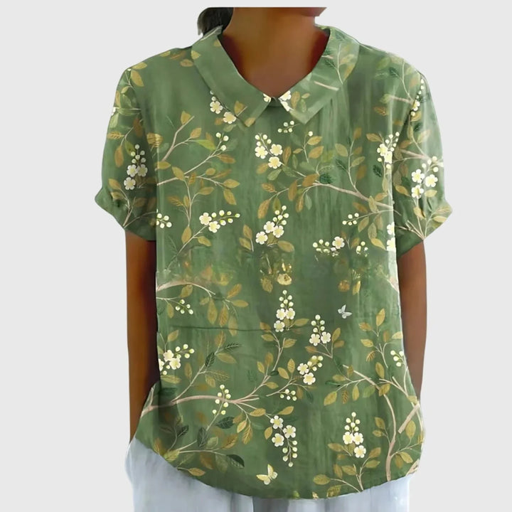 Women's linen floral blouse in light yellow showing climbing botanical print detail