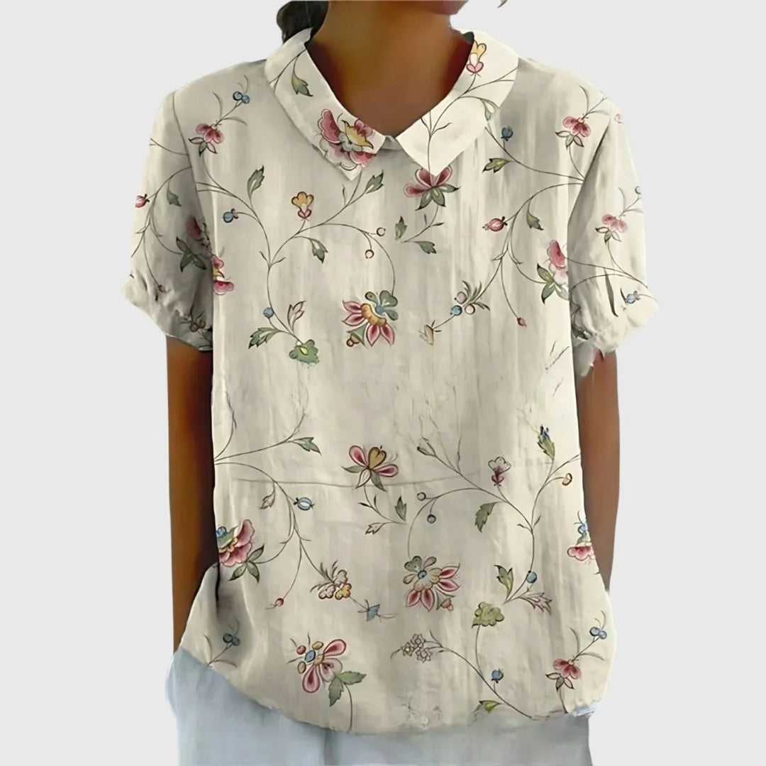 Detail shot of Peter Pan collar on women's linen floral blouse with botanical print