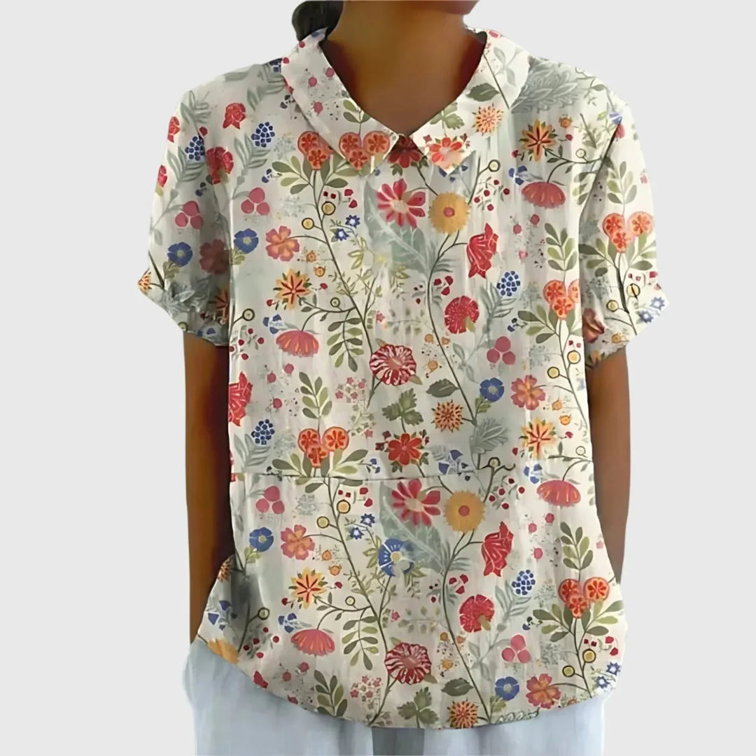 Back view of women's linen floral blouse showing short sleeve construction and length