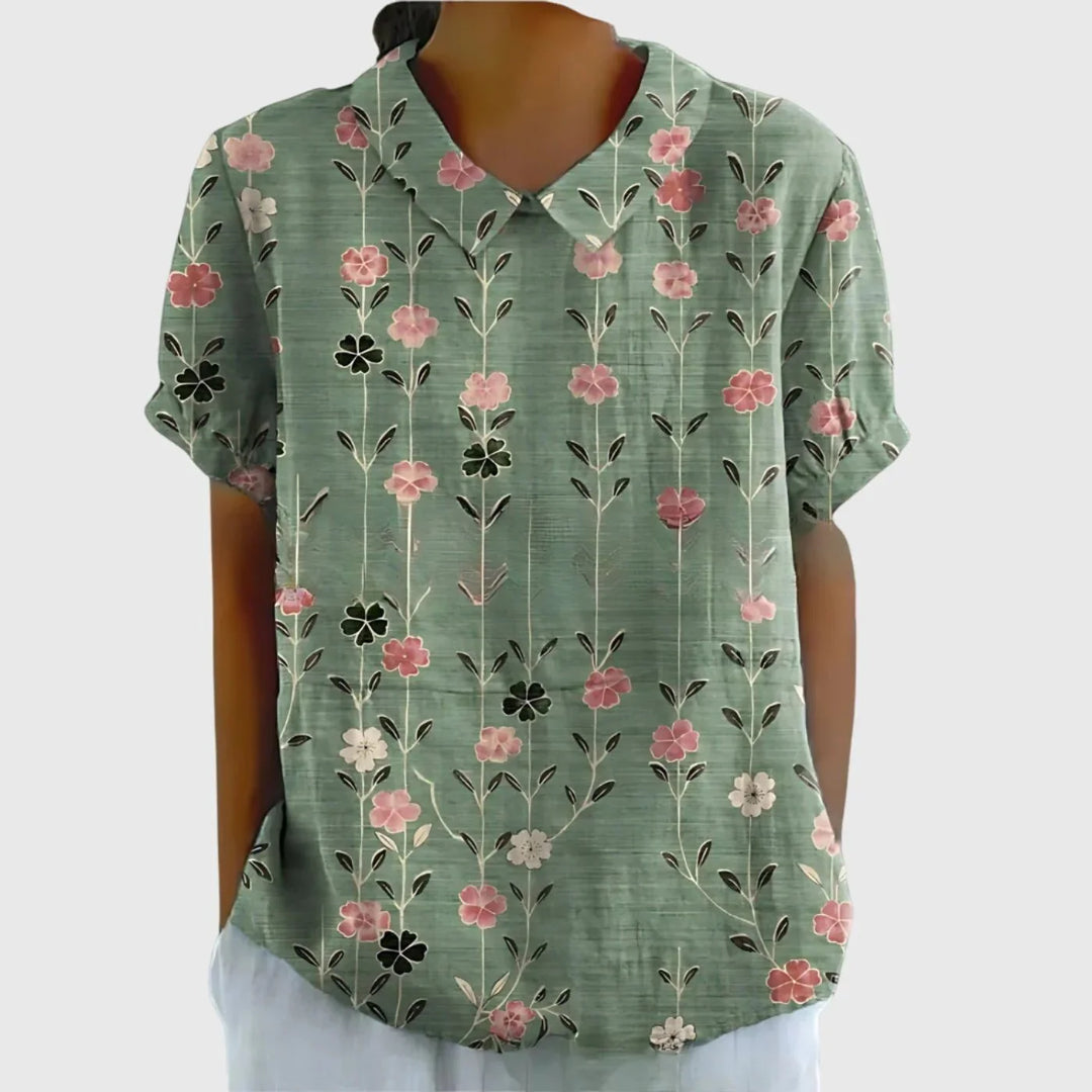Flat lay of women's linen floral blouse displaying full botanical print pattern