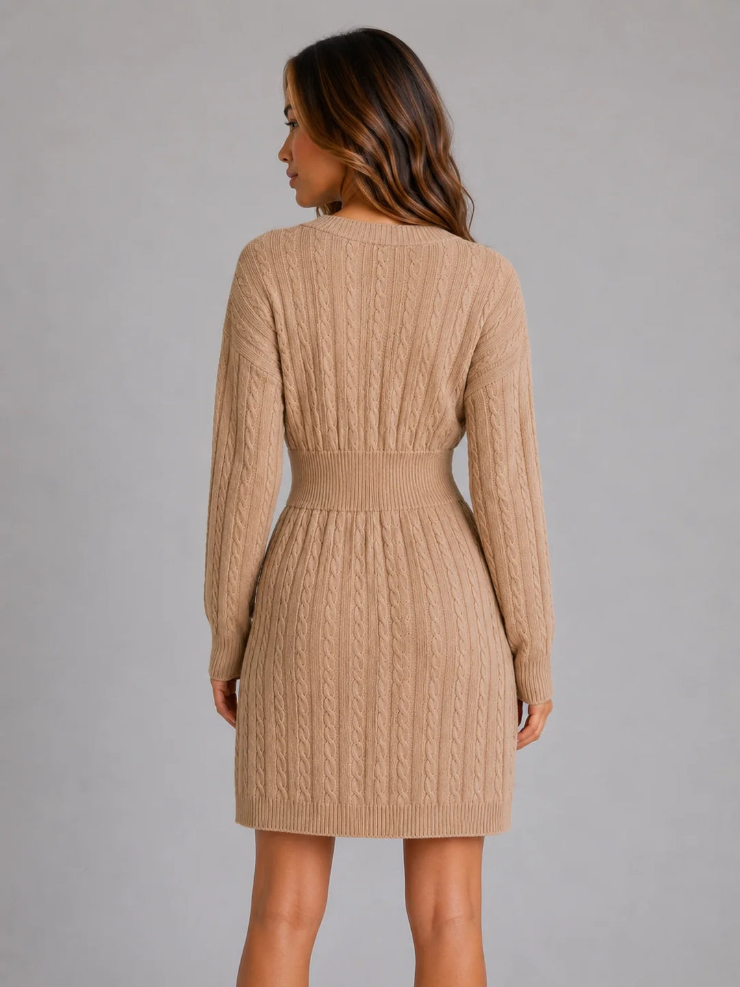 Front view of cable knit midi dress showing V-neckline and shirred waist detail in neutral tone