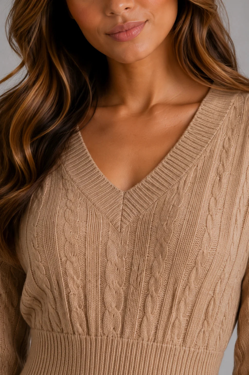 Close-up of cable knit texture and V-neck detail on beige midi dress