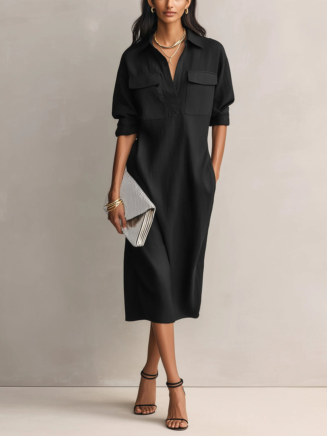 Women's midi shirt dress in black with collared V-neckline and dual chest pockets