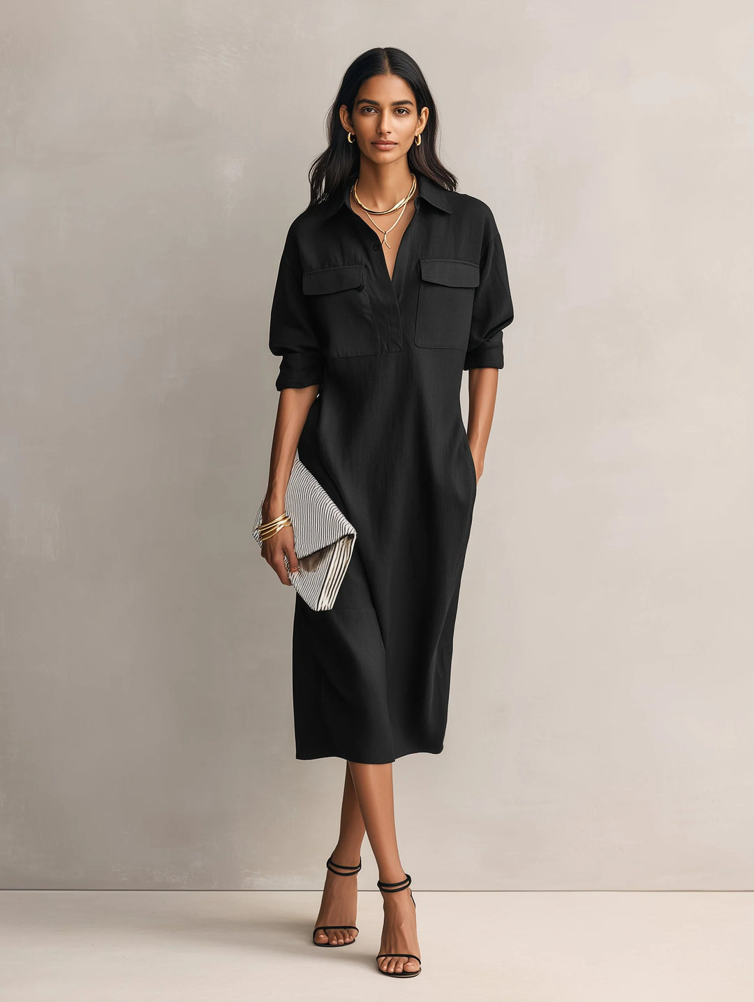 Side profile of women's midi shirt dress displaying relaxed fit and mid-calf length