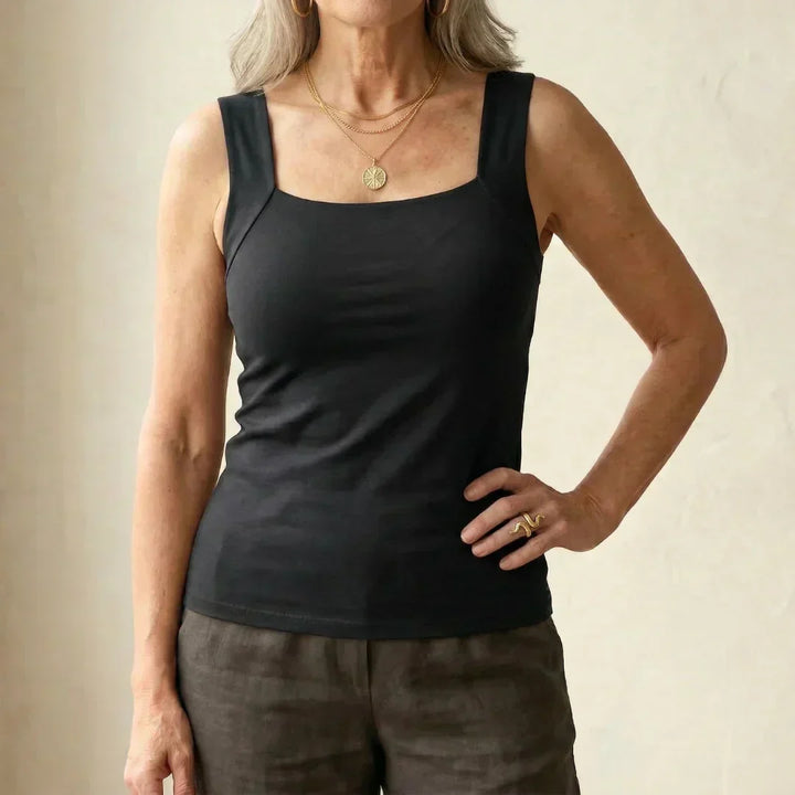 Woman styling fitted tank top with casual bottoms for comfortable everyday look