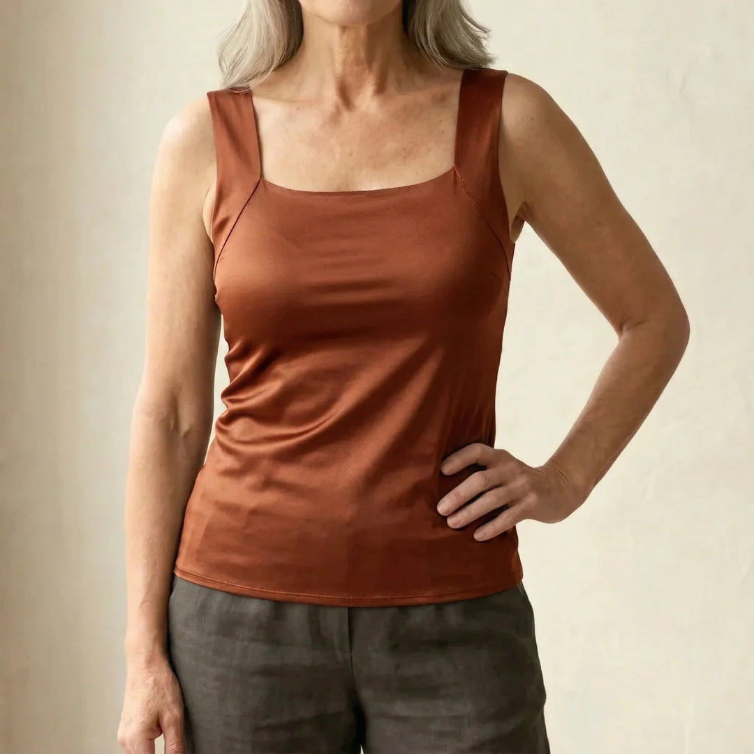 Woman wearing taupe square neck tank top showing close-fitting cut and supportive straps