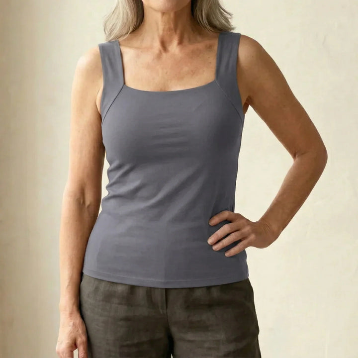 Woman in square neck tank top paired with tailored trousers for day-to-evening styling