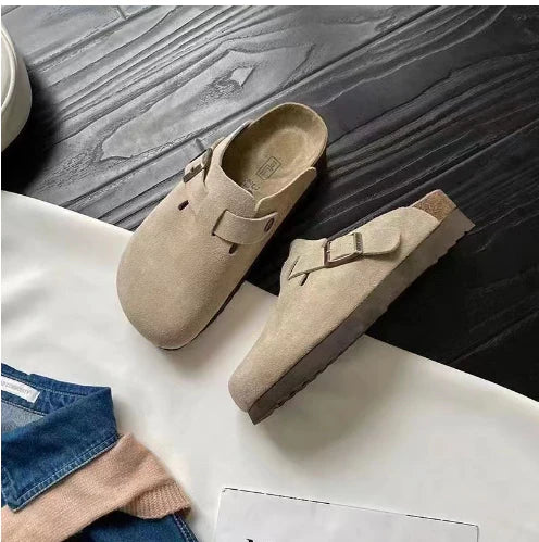 Overhead view of tan suede slip-on clogs with adjustable strap and contoured insole