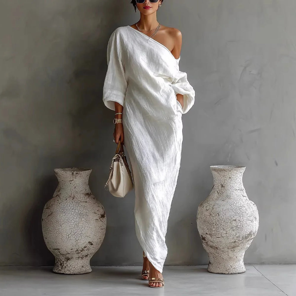 Side view of relaxed fit maxi dress with one-shoulder design and voluminous sleeves
