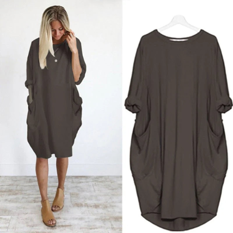 Oversized midi dress with batwing sleeves and side pockets in versatile design