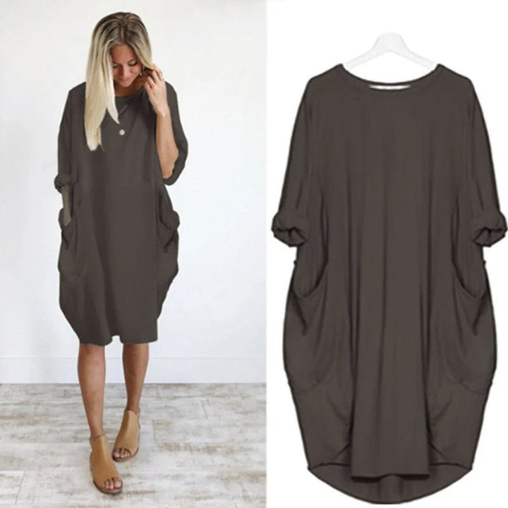 Oversized midi dress with batwing sleeves and side pockets in versatile design