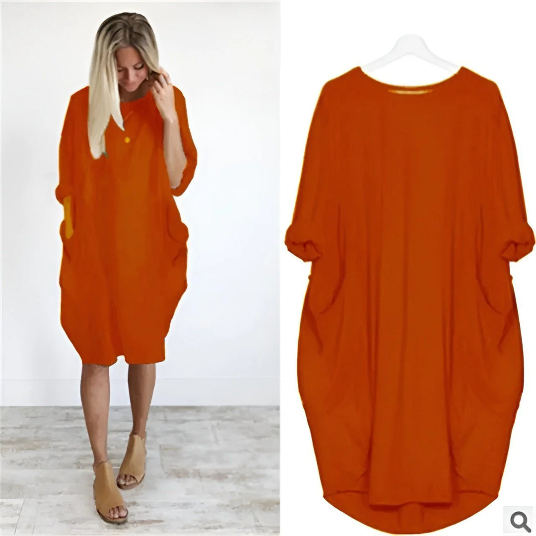 Full length view of oversized midi dress with batwing sleeves and knee-length hem