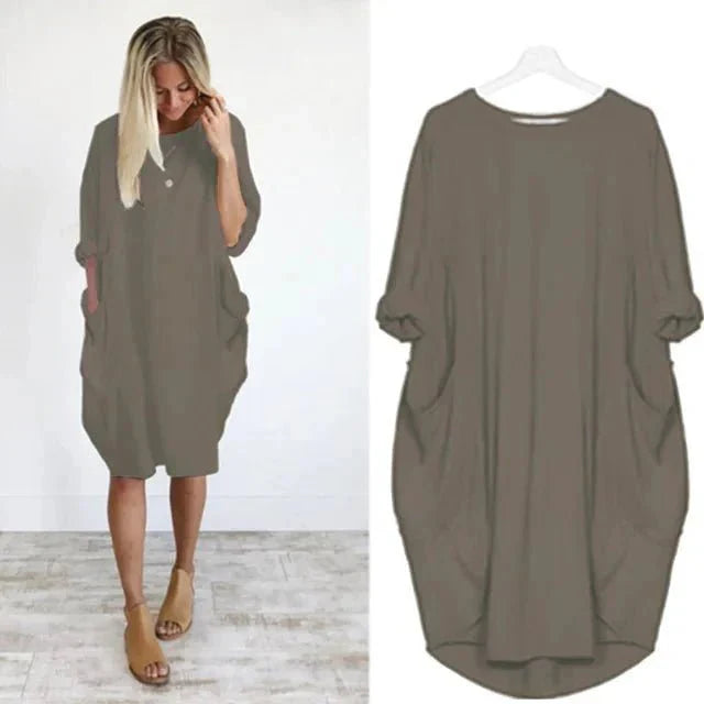 Close-up of oversized midi dress fabric showing soft drape and side pocket placement