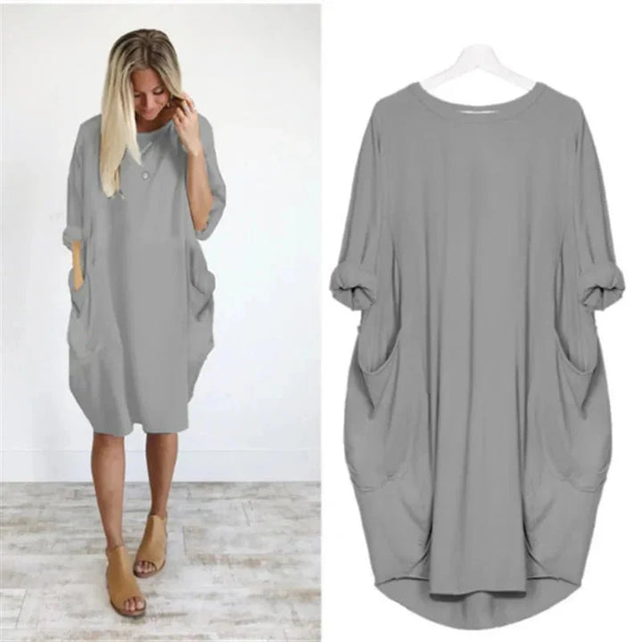Oversized midi dress with batwing sleeves styled with ankle boots for casual wear