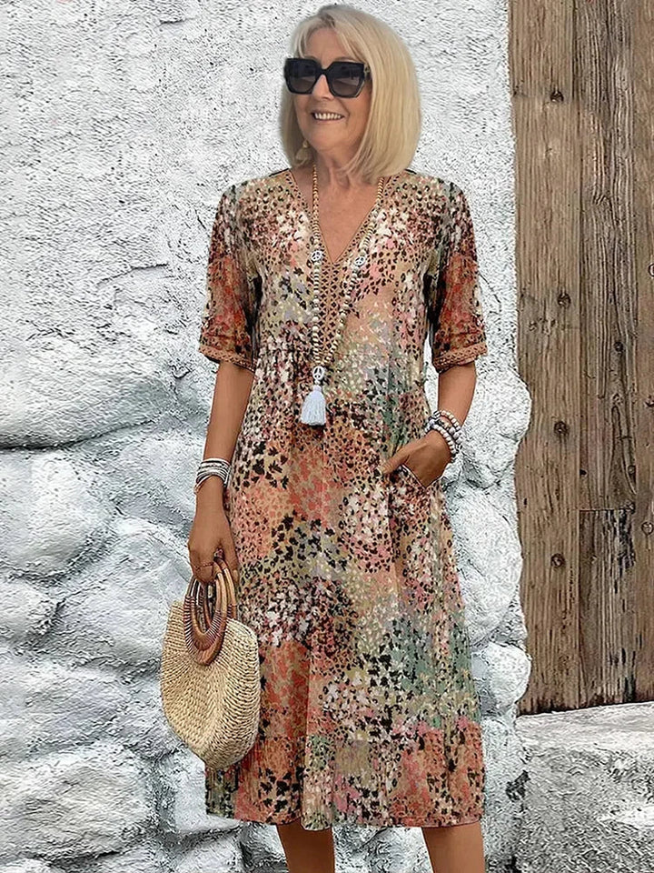 Full-length view of printed midi dress showing graceful A-line skirt and mid-calf hemline
