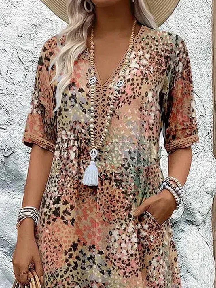 Back view of printed midi dress displaying flowing silhouette and vibrant pattern detail