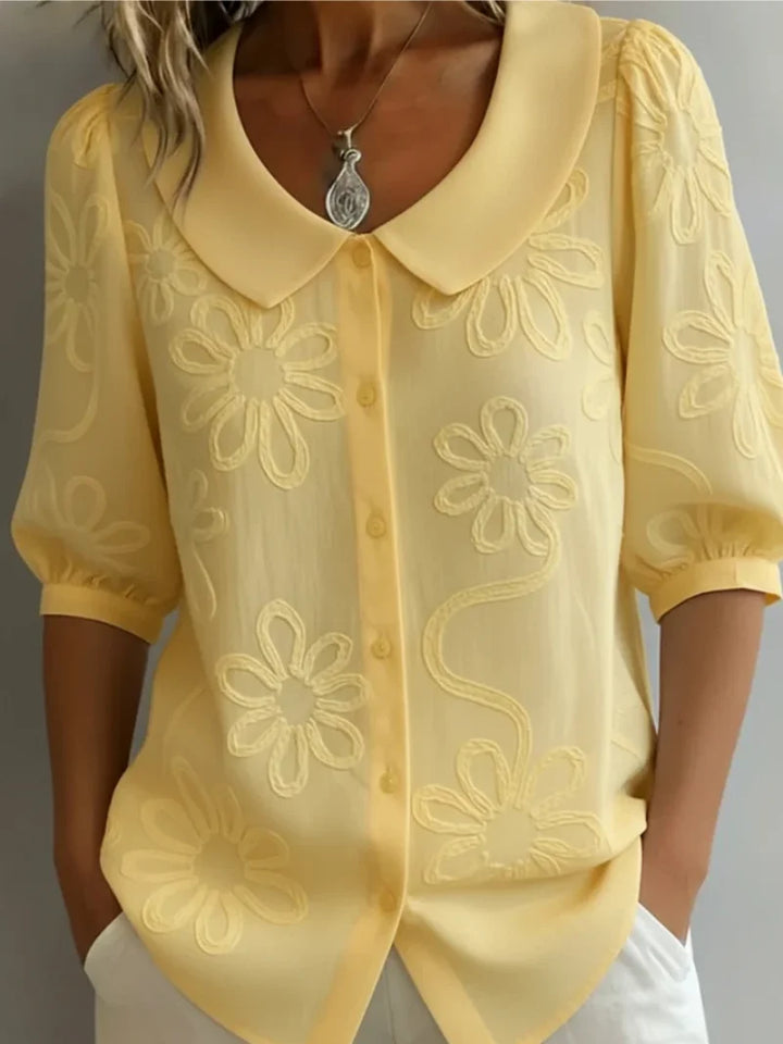 Women's embroidered floral blouse in yellow with rounded collar and button-front closure
