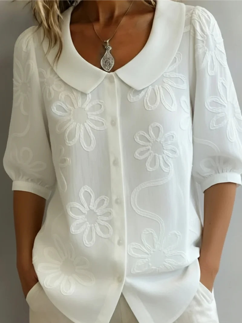 Side view of women's embroidered blouse showing relaxed fit and short sleeves