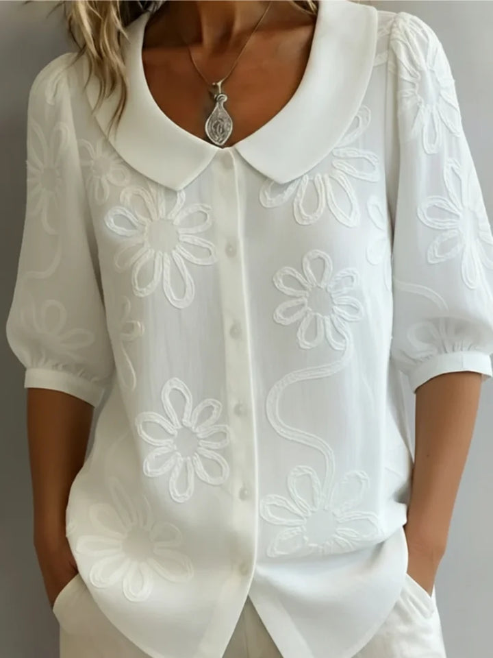 Side view of women's embroidered blouse showing relaxed fit and short sleeves