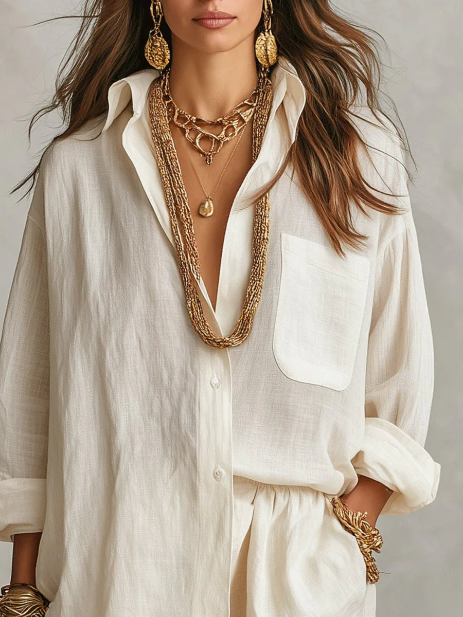 Detail of button-through closure and patch pocket on oversized linen shirt