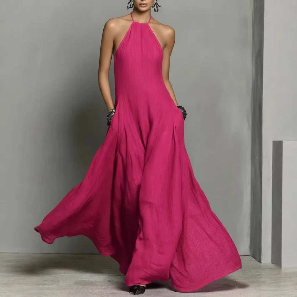 Flowing halter neck maxi dress with lightweight woven fabric draping gracefully to the floor