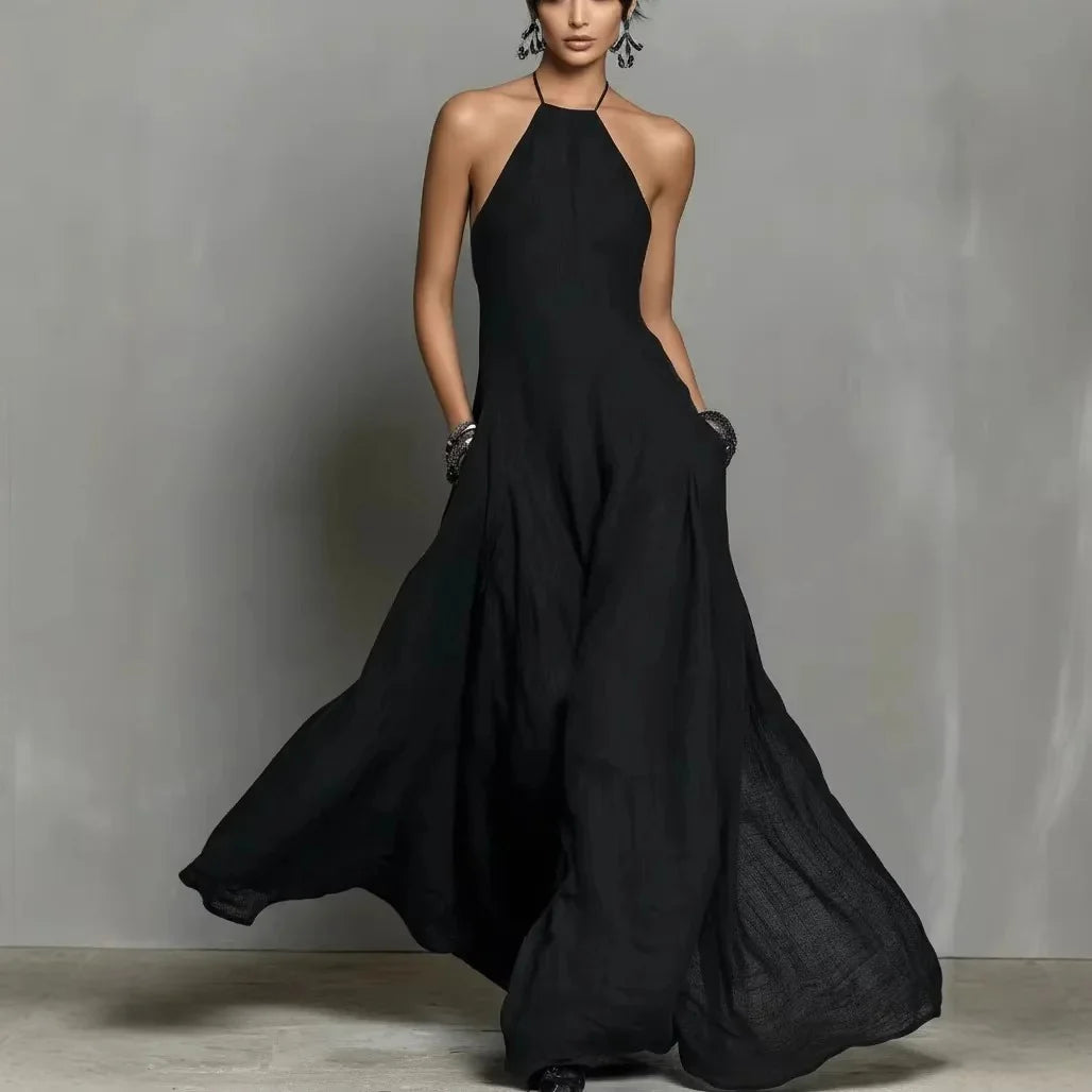Side view of floor-length halter dress with relaxed fit and natural fabric drape